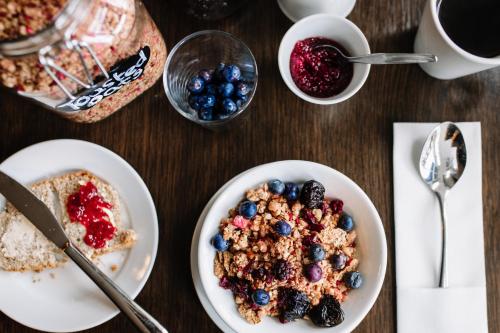 a wooden table with plates of breakfast foods and a cup of coffee at Ralph's in Moira