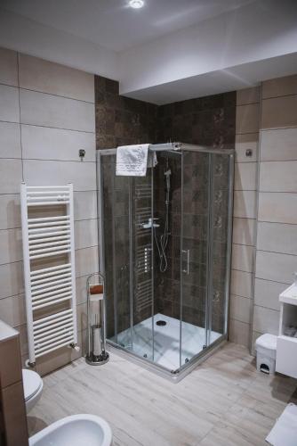 a bathroom with a shower with a glass door at Hotel Bacchus in Livno