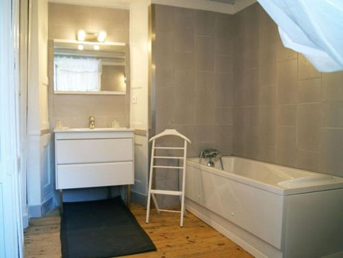 a bathroom with a sink and a tub and a ladder at Chambres d'hôtes Château de Bonabry in Hillion