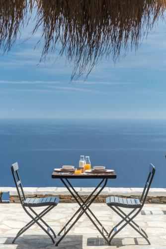 a table and two chairs on the beach at Verina Astra in Artemonas