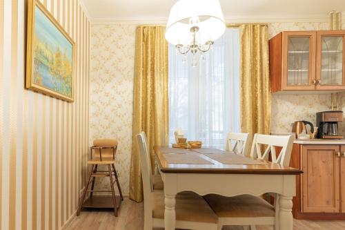 a dining room with a table and chairs in a kitchen at Videviku Villa Apartments in Tallinn