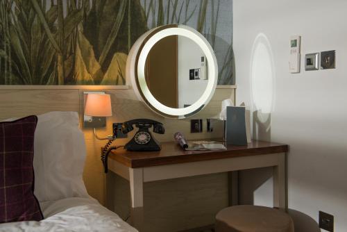 a room with a mirror and a telephone on a table at Judge's Lodging in York