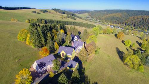 an aerial view of a large house in a field at Berghotel Talblick in Holzhau