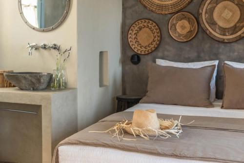 a bedroom with a bed with a hat on it at Verina Astra in Artemonas