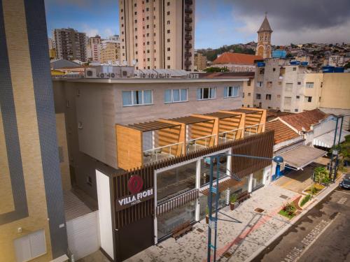 a view of a building with a view of a city at Hotel Villa Fiori in Poços de Caldas