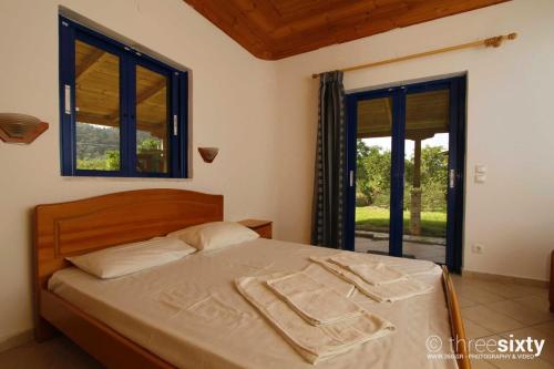 a bedroom with a bed with two towels on it at Orange Apartments in Vasiliki