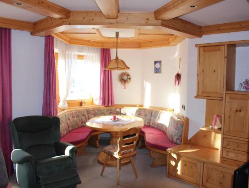 a living room with a couch and a table at Appartementhaus Egger in Kaprun