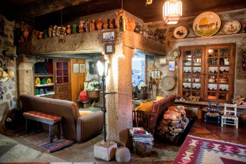 a living room with two couches and a table at Quinta de Santa Baia in Gaifar