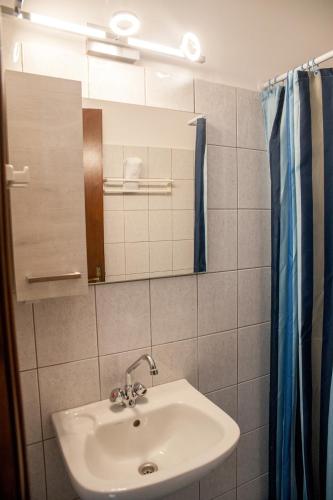 a bathroom with a sink and a mirror at Evianna Studios in Mousata