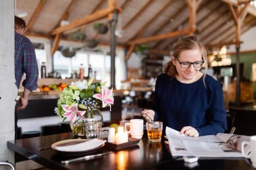 a woman sitting at a table in a restaurant at CPH Hotel in Copenhagen
