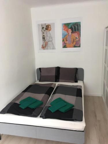 iHome Apartman 8.0 في بيتْش: سرير في غرفة مع صورتين على الحائط