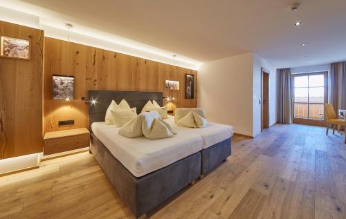 a large bedroom with a large bed with wooden walls at Bauernhof Hotel Oberschwarzach in Saalbach Hinterglemm