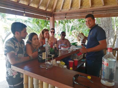a group of people standing around a bar at Sonny Island Resort in Punta Bajo Rico
