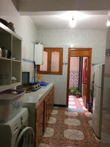 a kitchen with a sink and a stove top oven at Senhaja Suite in Targuist