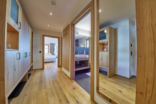 a hallway of a house with a bathroom and a bedroom at Bauernhof Hotel Oberschwarzach in Saalbach Hinterglemm