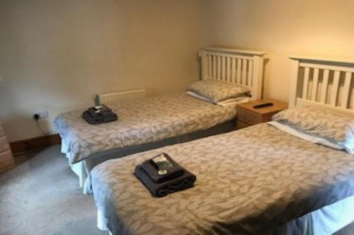 a room with two beds with a suitcase on them at The Dolphin Inn in Kingsbridge
