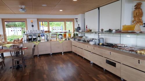 a large kitchen with wooden counters and a table at Berghotel Schonhalden in Flums