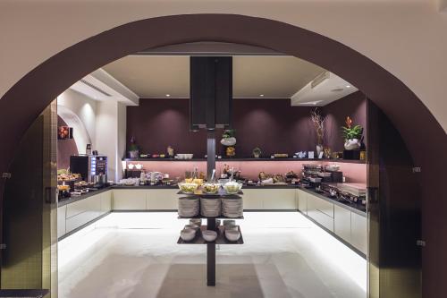 a kitchen area with a table and chairs at Rome Life Hotel in Rome