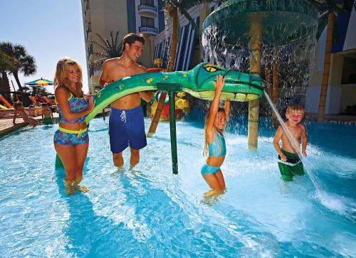 a group of people in the water at a resort at Compass Cove in Myrtle Beach