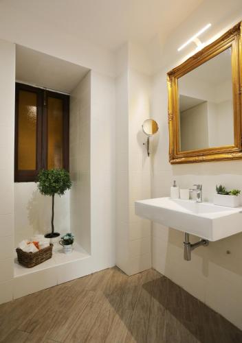 a bathroom with a sink and a mirror at Le Suites Del Duomo House in Catania