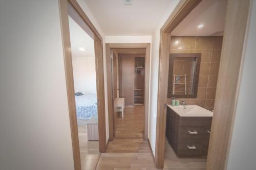 a bathroom with a sink and a mirror at Las Catedrales in Foz