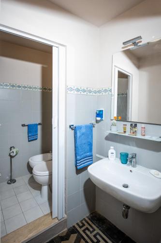 a white bathroom with a sink and a toilet at Appartamento Eden Tuscany in Casciana Terme