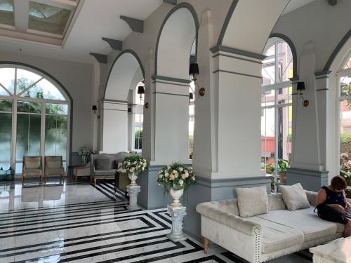 eine Frau, die auf einer Couch in einem Wohnzimmer sitzt in der Unterkunft Seven Seas Condo Resort Jomtien in Jomtien Beach