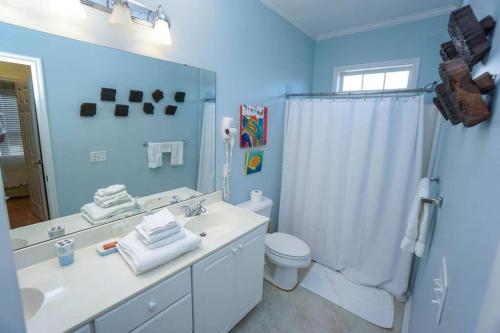 a bathroom with a sink and a toilet and a shower at Paradise on Nautical Watch **Pool Just Steps Away** in Harbor Island