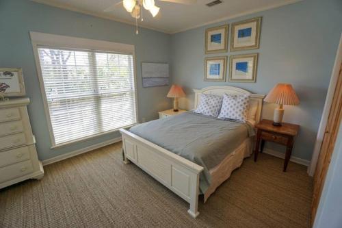 a bedroom with a large bed and a window at Paradise on Nautical Watch **Pool Just Steps Away** in Harbor Island