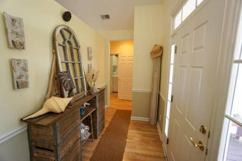 a hallway with a large mirror and a door at Paradise on Nautical Watch **Pool Just Steps Away** in Harbor Island