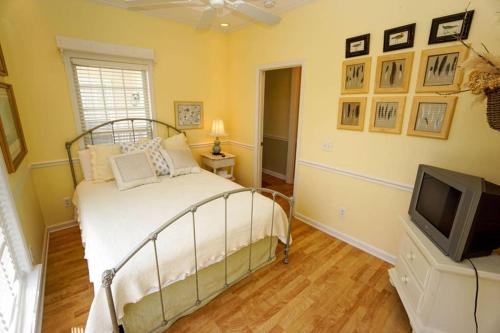 a bedroom with a bed and a television at Paradise on Nautical Watch **Pool Just Steps Away** in Harbor Island