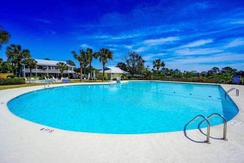 a large swimming pool with blue water at Paradise on Nautical Watch **Pool Just Steps Away** in Harbor Island