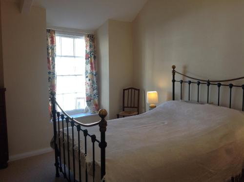 a bedroom with a large bed and a window at 6 Hill Street, Haverfordwest. in Pembrokeshire