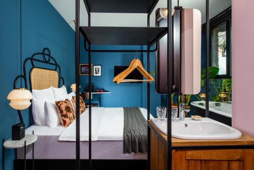 a bedroom with a bed and a tub and a sink at Communal Hotel Sololaki in Tbilisi City