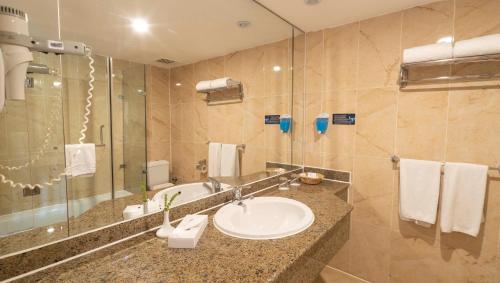 a bathroom with a sink and a large mirror at Blend Elphistone Resort Marsa Alam in Abu Dabab