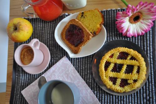 a table with a plate of cake and a cup of coffee at B&B Terra di Marca in Montefortino