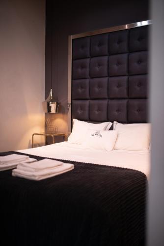 a bedroom with a large bed with a black headboard at Bliss Lisbon Apartments - Bairro Alto in Lisbon