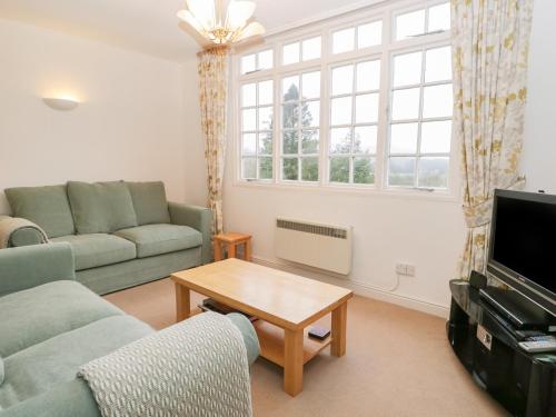 a living room with a couch and a table at Sethera in Ambleside