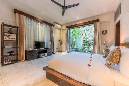 En eller flere senge i et værelse på Villa Saba 10