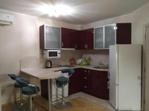a kitchen with a refrigerator and a table and chairs at RUBIN-2 in Pomorie