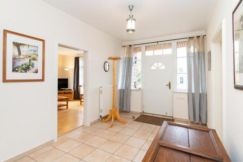 a hallway with a door with a clock on the wall at Fehmarn Mein Urlaub in Fehmarn
