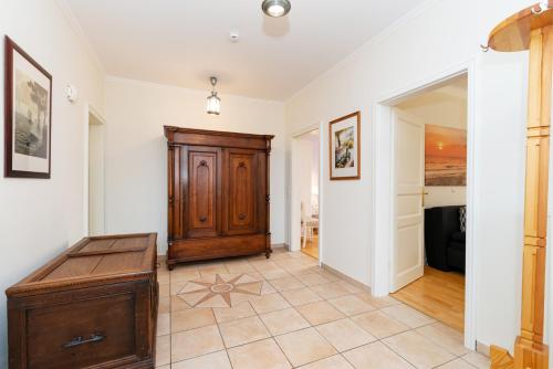 a room with a wooden door and a tiled floor at Fehmarn Mein Urlaub in Fehmarn
