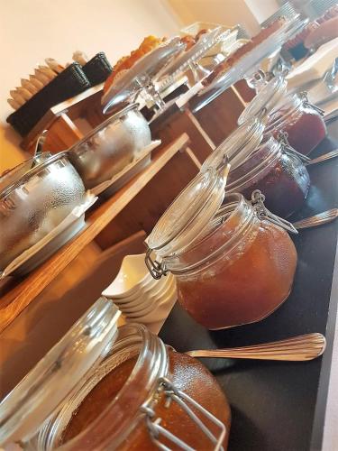 a bunch of jars of honey on a table at Villa Curina Resort in Castelnuovo Berardenga