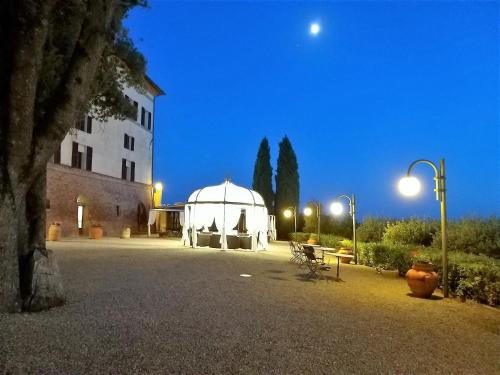 a large white tent in front of a building at night at Villa Curina Resort in Castelnuovo Berardenga