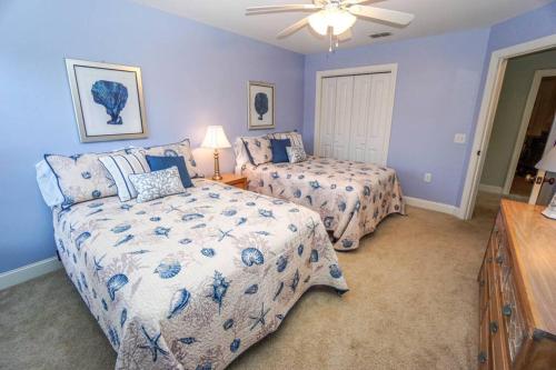 a bedroom with two beds and a ceiling fan at Ideal Location! Perfect for Graduations and Lowcountry Getaways! in Port Royal