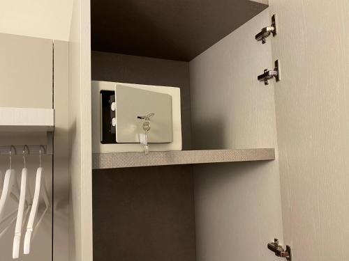 a bathroom with a sink and a shelf at B&B ALDA in Levanto