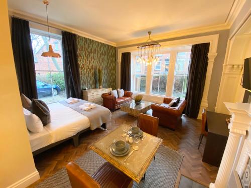 un soggiorno con letto, divano e tavolo di The Deakin at Claremont Serviced Apartments a Leeds