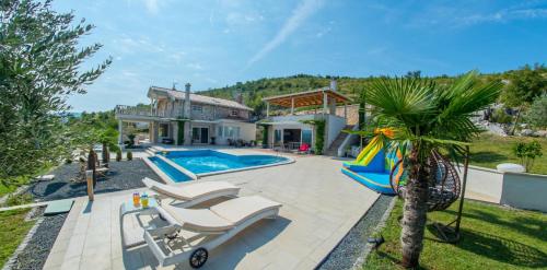 a villa with a swimming pool and a house at Villa VAND Paradiso in Međugorje