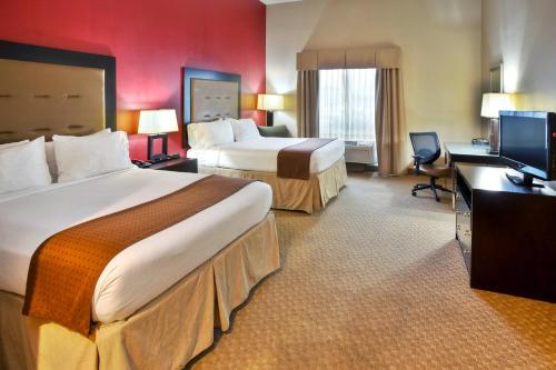 a hotel room with two beds and a flat screen tv at Holiday Inn Killeen Fort Hood, an IHG Hotel in Killeen