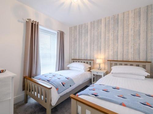 a bedroom with two beds and a window at St James By the Quay in Ilfracombe